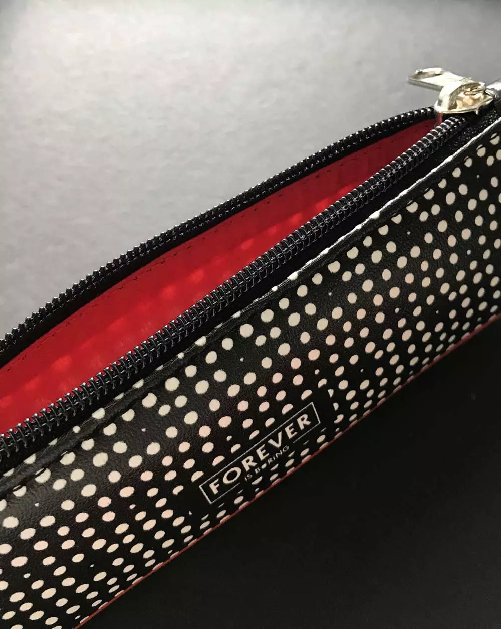 Pencil Case DOTS with black and white design with wild red lining and Forever is Boring logo.